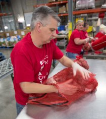 Packing the five pound bags into 40-pound sacks.