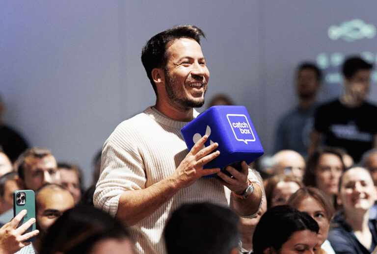 A meeting participant using a Catch Box microphone