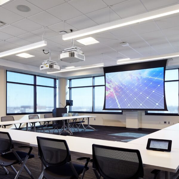 large U shaped table around a projection screen