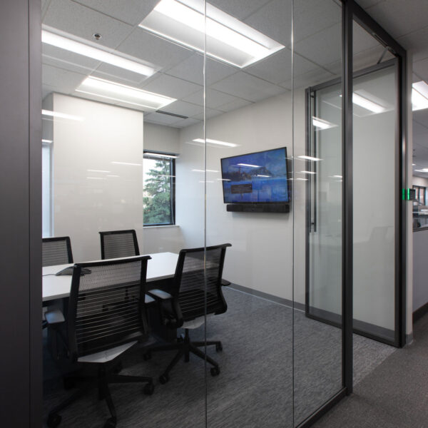 Huddle Room with 4 chairs and a TV with glass walls