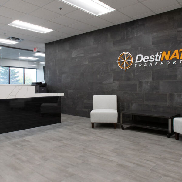 Destination Transport Lobby with Logo Sign, soft seating, and receptionist desk