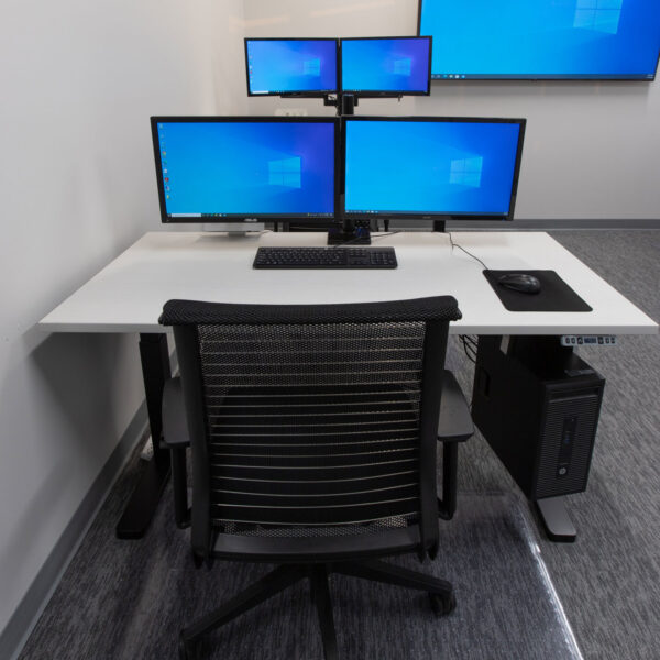 desk with multiple monitors