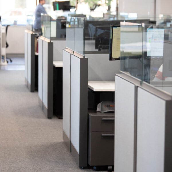 a row of cubicle panels that are fabric and glass at the top