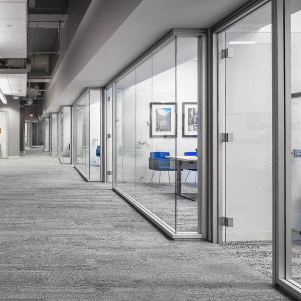 a hallway showing glass fronts of private offices