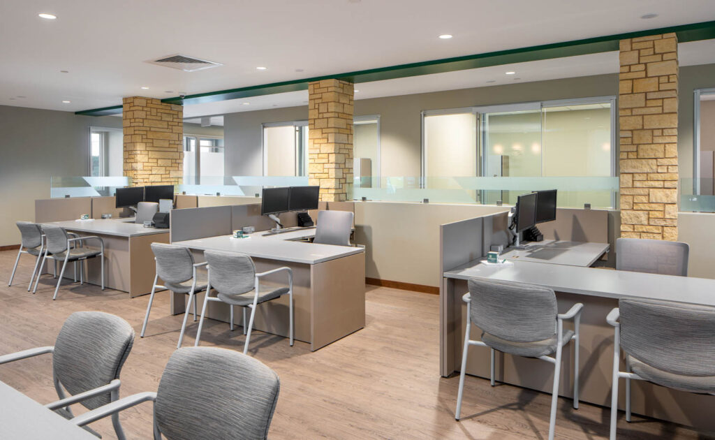 Customer experience center desks with each desk having task seating and 2 guest chairs
