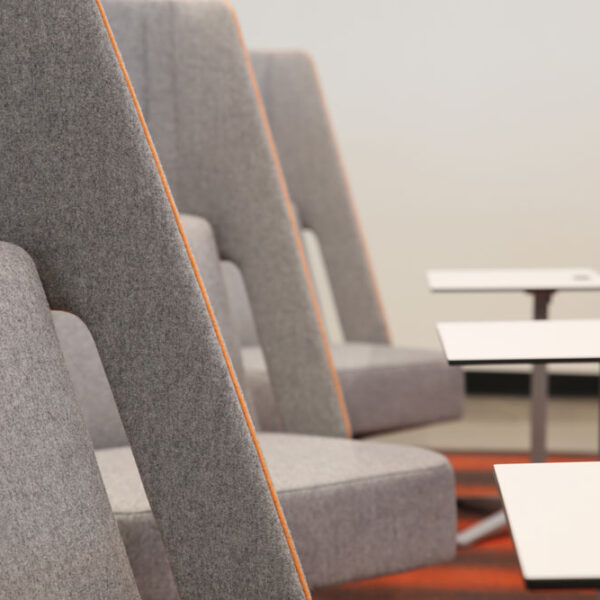 Close up view of lounge seating with laptops tables for comfort and productivity