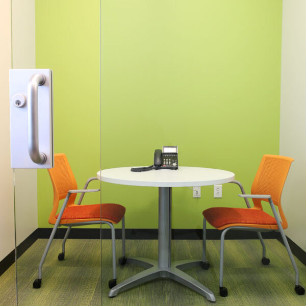 meeting room with small, round table and 2 chairs for quick collaboration